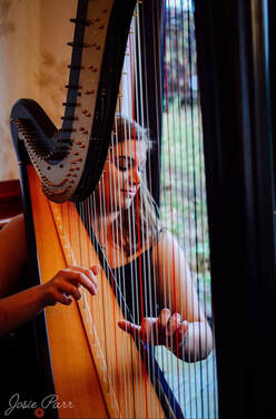 harriet playing the harp at a wedding ceremony at barnsdale hall