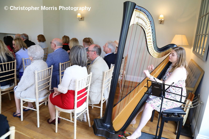 harpist performing at wedding ceremony at irnham hall