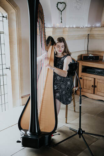 harriet flather performing the harp at a wedding at normanton church rutland water